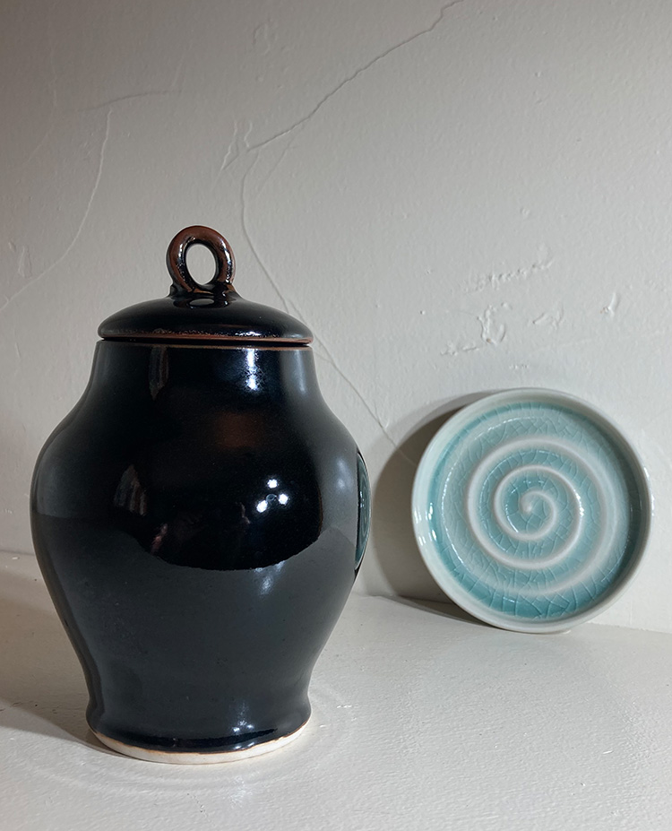 porcelain ginger jar with cover in Tenmoku glaze shown with celadon glaze soap dish hand thrown by Converse Fields for Fields Pottery